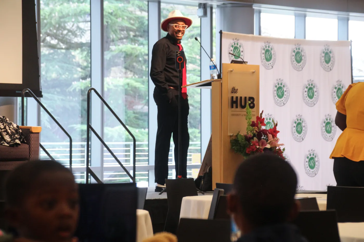 D smiling on stage at The HUB before a talk
